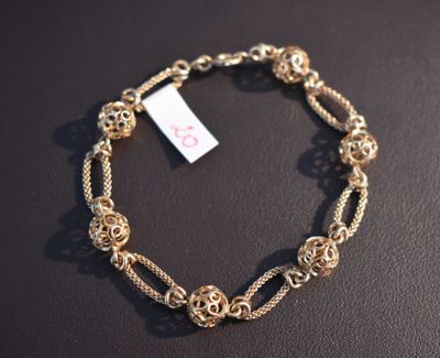 a close up of a bracelet on a table with a price tag