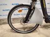 a close up of a bicycle parked in front of a wall