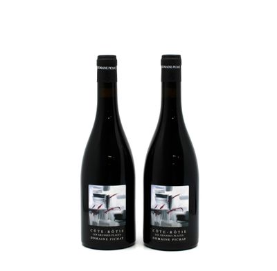 two bottles of wine sitting next to each other on a white surface