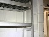 a metal shelf in the corner of a room