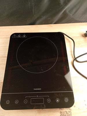 a black stove top with a black burner on it