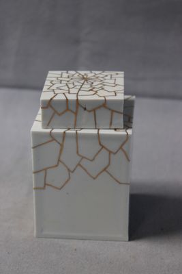 a small white box with a cracky design on it