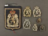 a group of badges including a badge, a badge, and other items