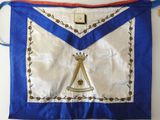 a close up of a blue and white apron with a crown on it