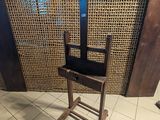 a wooden chair that is on a stand in a room