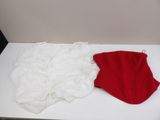 a white and red shirt and a red hat on a white table