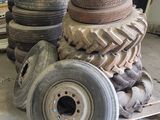 a pile of tires sitting on top of a pallet in a garage