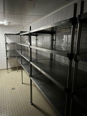 a long metal shelf in the middle of a room