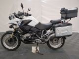 a picture of a white and black motorcycle parked on a checkered floor
