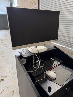 a desk with a keyboard, mouse, and monitor on it