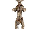 an image of a wooden statue of a man with his hands on his hips