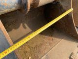 a measuring tape that is on the side of a pipe