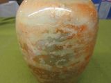 a vase sitting on a table with a box in the background