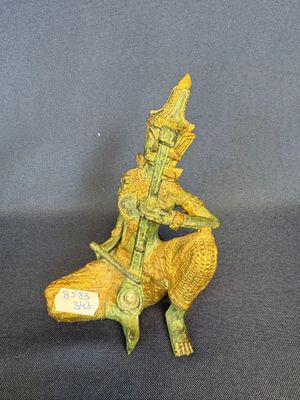 bronze figurine of a man sitting on a chair with a guitar in his hand