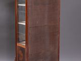 an antique wooden display cabinet with glass doors and drawers