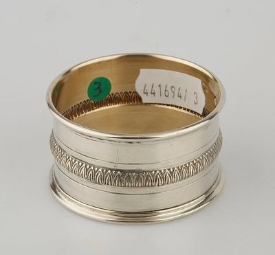 a silver ring with a green stone in the center