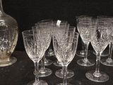 many wine glasses and a decanter on a table