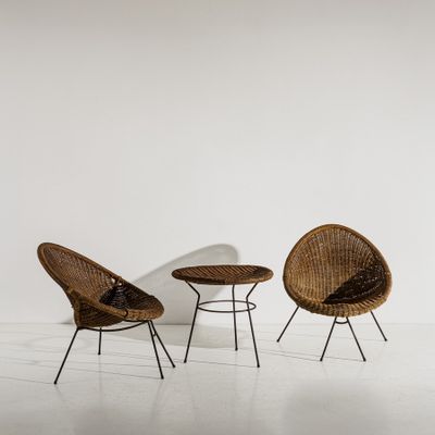 two chairs and a table in a room with white walls