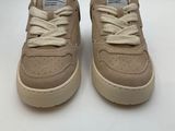 a pair of beige sneakers with white laces on them