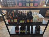 many bottles of beer sitting on a shelf in a store