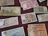 many different bank notes laid out on a table