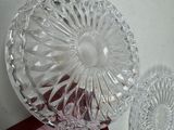 a glass bowl and a glass plate on a table