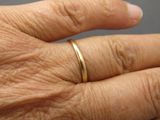 a close up of a person ' s hand with a ring on it