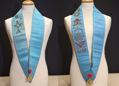 two mannequins with blue sashes on them