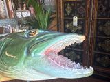 a fake alligator head on display in a museum