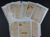 a lot of old papers on a table with a cell phone