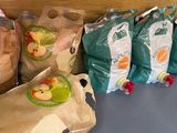several bags of food are lined up on a counter