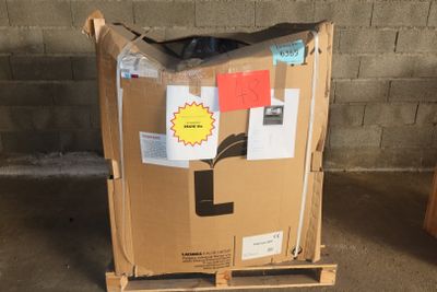 a cardboard box on a pallet with a sticker on it