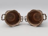 pair of silver plated vases with handles and handles
