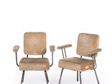 pair of mid - century chairs with upholstered backrests and metal legs