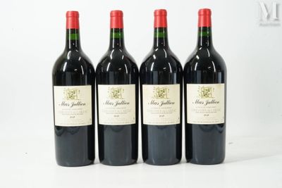 four bottles of red wine are lined up on a table