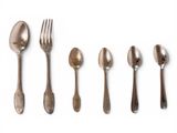 several spoons, forks and spoons are lined up on a white surface