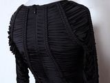 black long sleeved dress with ruffles on a mannequin mannequin mannequin mannequin mannequin mannequin mannequin
