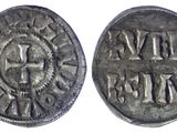 a silver coin with a cross on the front and a cross on the back