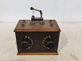 an old fashioned radio sitting on top of a wooden table