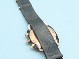a watch that is laying on a blue surface