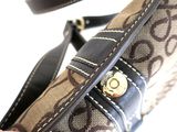 a person holding a purse with a strap on it