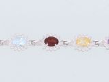several different colored stones are arranged in a row on a white surface