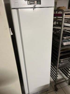 an image of a refrigerator in a kitchen with a rack of trays
