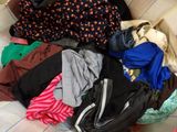 a box full of clothes sitting on a bed