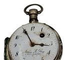 a close up of a pocket watch on a white background