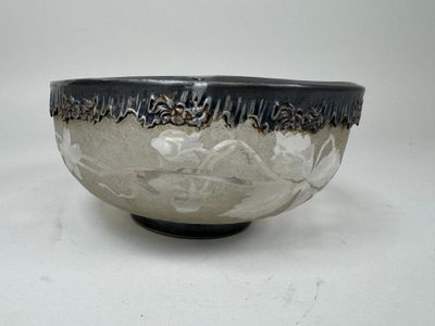 a black and white bowl sitting on a white surface