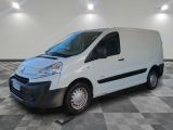 the white van is parked on a checkered floor in a room