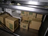 many boxes of food sitting on a shelf in a kitchen
