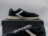 a pair of black and white sneakers sitting on top of a box