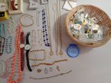 a basket full of assorted jewelry on a table
